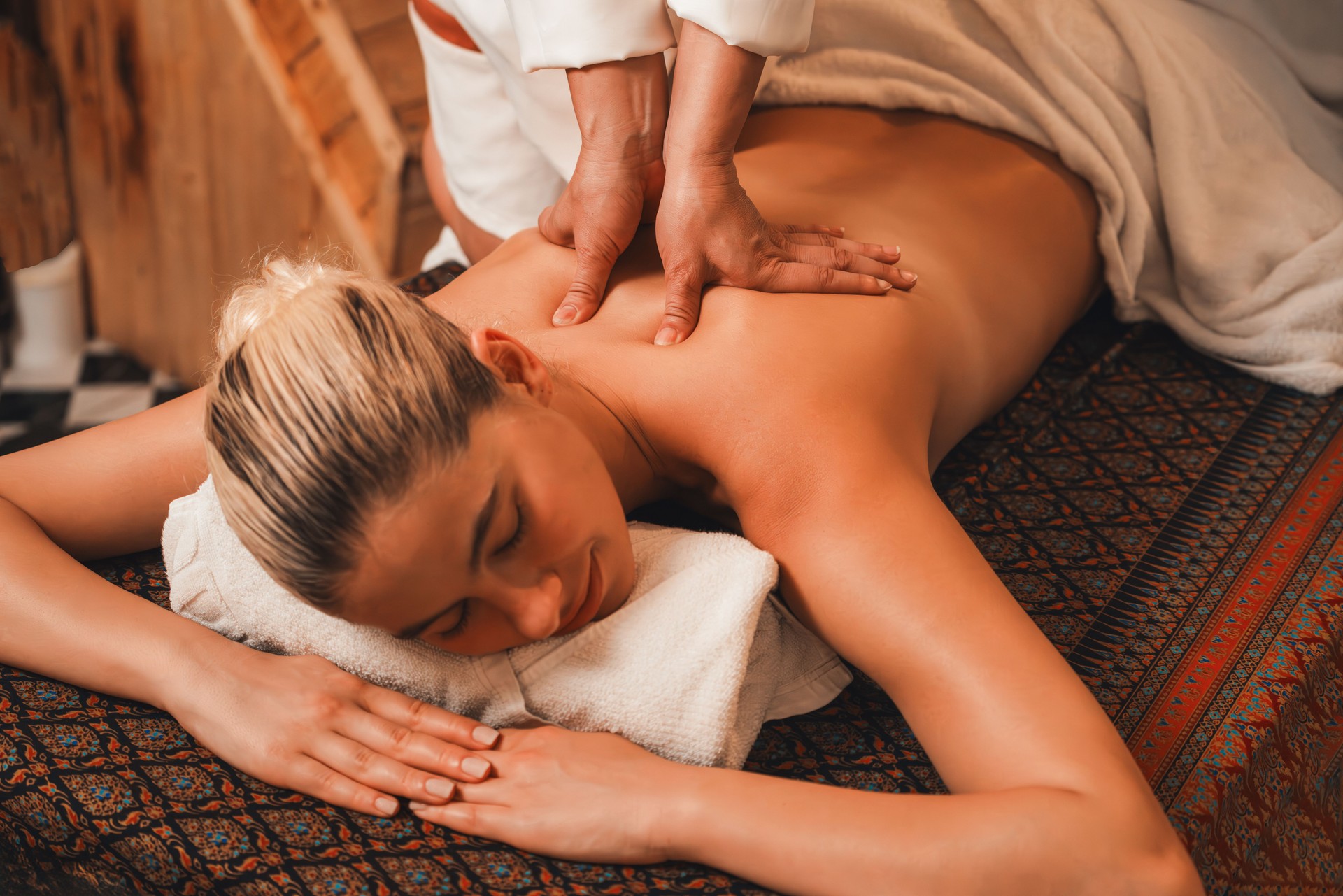 Attractive caucasian woman having back massage at warm sauna room. Tranquility. Attractive caucasian woman having back massage at warm sauna room. Tranquility.